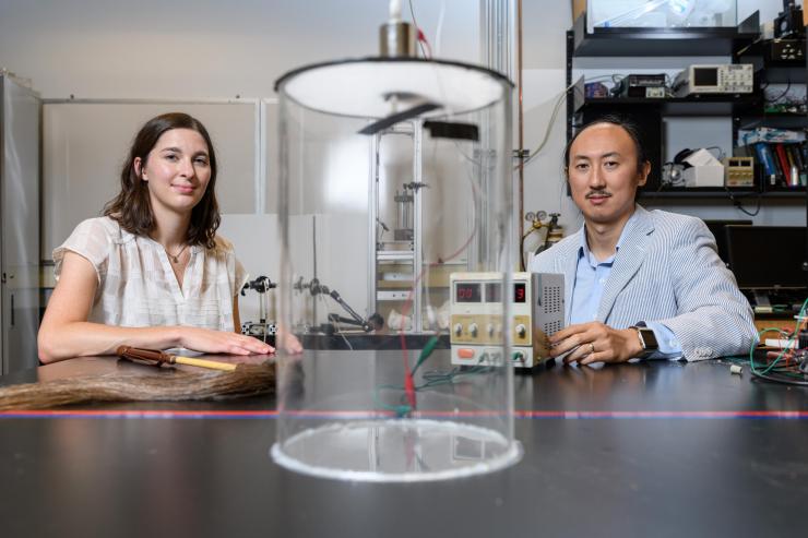 <p>Marguerite Matherne, a mechanical engineering Ph.D. student, and Professor David Hu, pose with the mammal tail simulator used to study the airflow needed to keep mosquitoes from landing. (Credit: Rob Felt, Georgia Tech)</p>