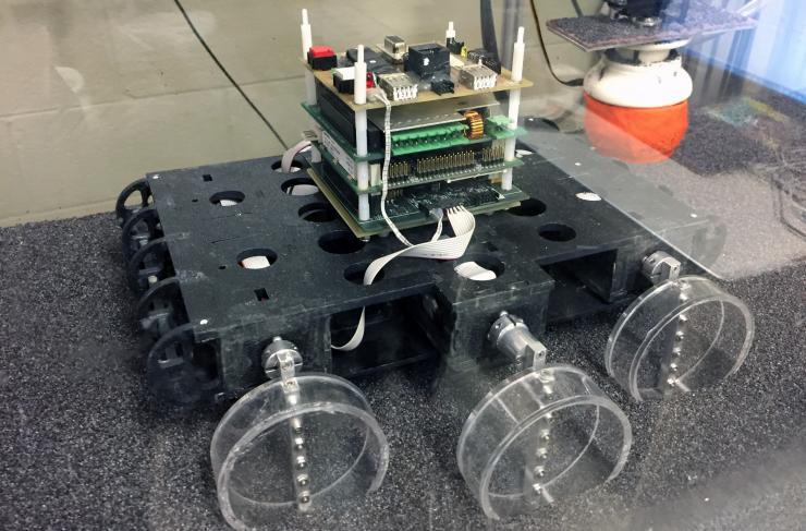 <p>Sandbot, a bio-inspired hexapedal robot, is shown in a trackway filled with poppy seeds to simulate various granular surfaces. The robot was used to study how the stiffness of a loosely-packed surface affects the ability to move across it. (Credit: John Toon, Georgia Tech)</p>