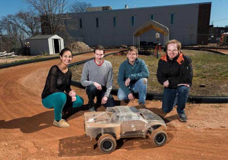 <p>Georgia Tech researchers are using an electric-powered autonomous vehicle to help driverless vehicles maintain control at the edge of their handling limits. Shown (l-r) are Georgia Tech students Sarah Selim, Brian Goldfain, Paul Drews, Grady Williams. (Credit: rob Felt)</p>
