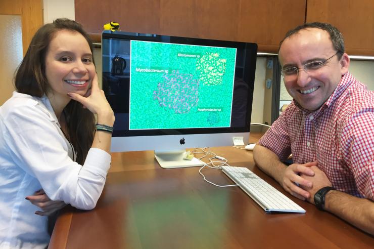 <p>Georgia Tech Doctoral Student Maria Juliana Soto-Girón and School of Civil and Environmental Engineering Professor Kostas Konstantinidis are shown with images of bacteria. Research done with scientists from the U.S. Environmental Protection Agency documented bacteria in shower hoses taken from hospital patient rooms. (Credit: John Toon, Georgia Tech).</p>