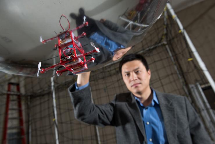 <p>Fumin Zhang, associate professor in the School of Electrical and Computer Engineering, works with small airborne blimps that can simulate the behavior of underwater vehicles for research purposes.</p>