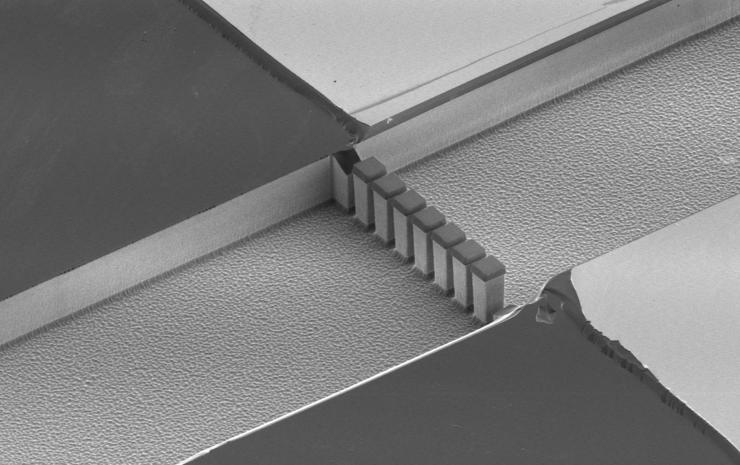 <p>The cell immobilization features inside the cell processing device: These 30 micron tall pillars are etched into silicon with a mere three microns between each column. The cells are approximately 10 microns and can’t get through the narrow openings. More than just a filter, these features allow researchers to concentrate the cells before extracting their contents.</p>