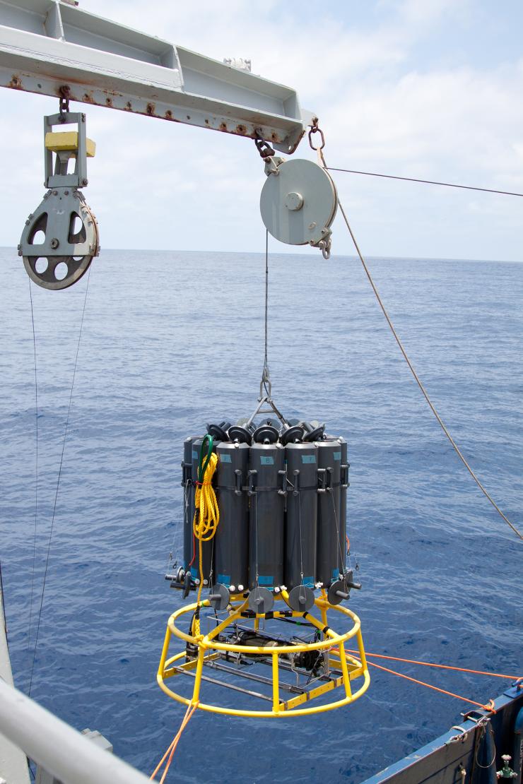 <p>A carrousel of collector tubes dangles from a crane before beginning its descent to the oxygen minimum zone off of Mexico's Pacific coast. Credit: Dr. Heather Olins</p><p> </p>