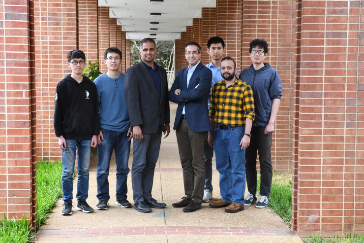 <p>Physicist Chandra Raman, middle left, and electrical engineer Farrokh Ayazi, middle right, were co-principal investigators in a Nature Communications study about the development of a miniaturized, improved atomic beam collimator. Here seen with members of their labs who participated in the study. First author Chao Li is standing behind Ayazi's left shoulder. Credit: Georgia Tech / Christopher Moore</p>
