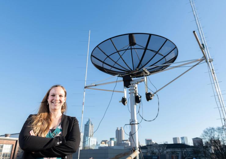 <p>Georgia Tech assistant professor Mariel Borowitz is shown with satellite communications equipment. Dramatic growth in the generation and collection of data will change the way federal agencies make data available. (Photo: Allison Carter, Georgia Tech)</p>