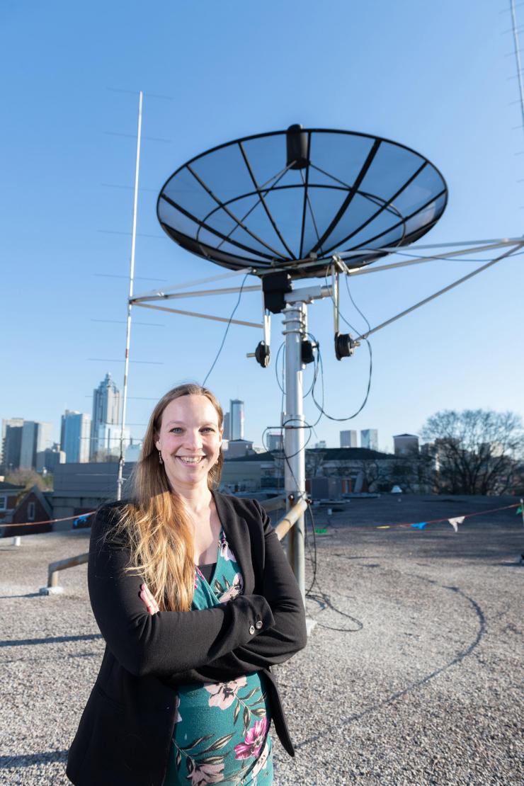 <p>Georgia Tech assistant professor Mariel Borowitz is shown with satellite communications equipment. Dramatic growth in the generation and collection of data will change the way federal agencies make data available. (Photo: Allison Carter, Georgia Tech)</p>