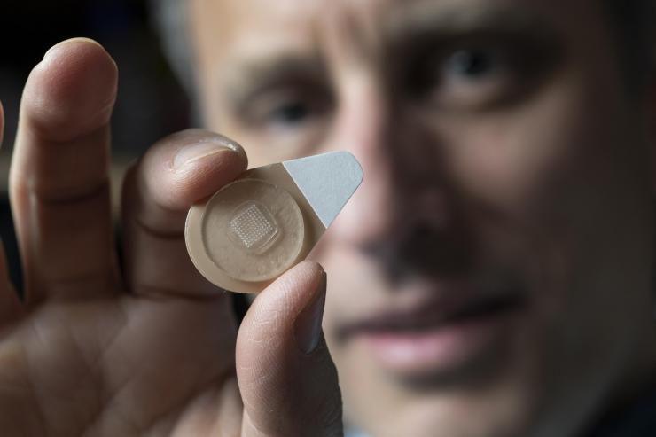 Regents Professor Mark Prausnitz holds an experimental microneedle contraceptive skin patch. Designed to be self-administered by women for long-acting contraception, the patch could provide a new family planning option. (Credit: Christopher Moore, Georgia Tech)