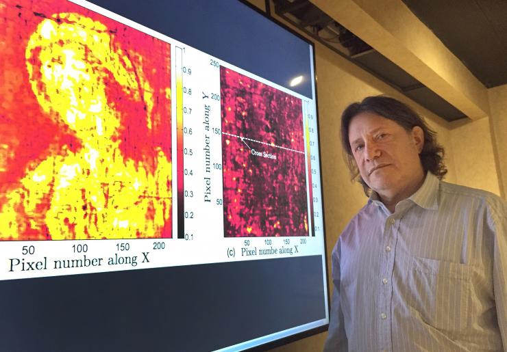 <p>Georgia Tech professor David Citrin is shown with images produced by a terahertz imaging technique. Researchers studied a 17th century painting using a terahertz reflectometry technique to analyze individual paint layers.(Credit: John Toon, Georgia Tech)</p>