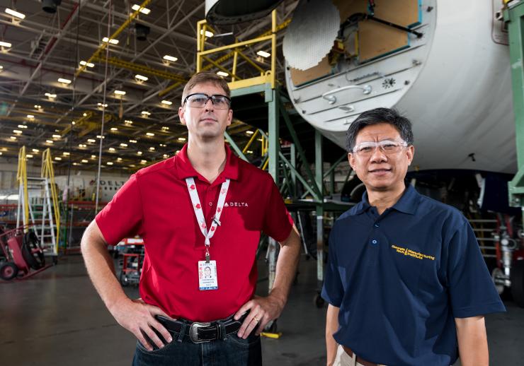 <p>Georgia Tech is working with Atlanta-based Delta Air Lines on procedures for repairing composite parts used in aircraft. Shown in a Delta maintenance facility are Todd Herrington, general manager of fleet projects at the company, and Chuck Zhang, a professor in Georgia Tech's Stewart School of Industrial and Systems Engineering. (Credit: Rob Felt, Georgia Tech)</p>