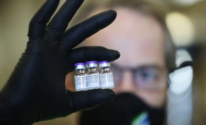 Researcher holding vaccine vials