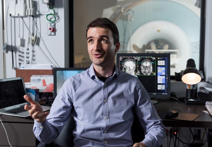 <p>Researcher Dobromir Rahnev, the study's principal investigator, sits in the Georgia Tech control room of a functional MRI scanner. Credit: Georgia Tech / Rob Felt</p>