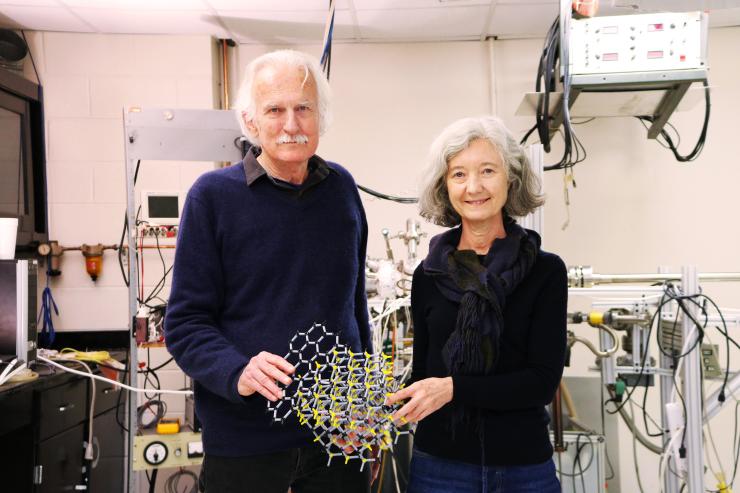 Walter de Heer and Claire Berger, physics professors, holding an atomic model of graphene (black atoms) on crystalline silicon carbide (yellow atoms) in the Epitaxial Graphene Lab at Georgia Tech. Credit: Jess Hunt-Ralston, Georgia Tech