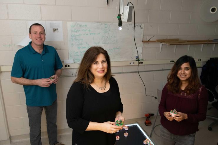 <p>Researchers at the Georgia Institute of Technology have been awarded $6.25 million to use collective emergent behavior to achieve task-oriented objectives. Shown are Dan Goldman, professor in the School of Physics; Dana Randall, co-director of the Institute for Data Engineering and Science, and Ph.D. student Bahnisikha Dutta. (Photo: Allison Carter, Georgia Tech)</p>