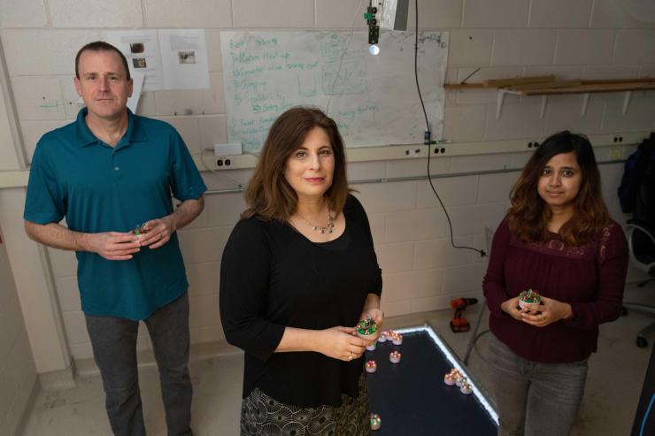 <p>Researchers at the Georgia Institute of Technology have been awarded $6.25 million to use collective emergent behavior to achieve task-oriented objectives. Shown are Dan Goldman, professor in the School of Physics; Dana Randall, co-director of the Institute for Data Engineering and Science, and Ph.D. student Bahnisikha Dutta. (Photo: Allison Carter, Georgia Tech)</p>