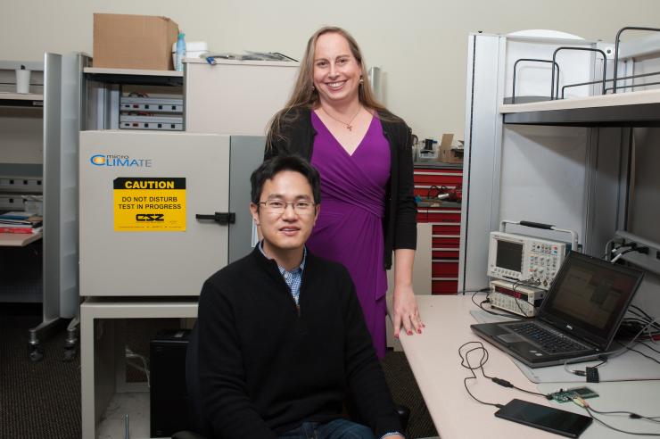 <p>Georgia Tech Graduate Research Assistant Sihwan Kim and Professor Jennifer Hasler are shown testing FPAA devices at a lab bench. (Credit: Fitrah Hamid, Georgia Tech)</p>