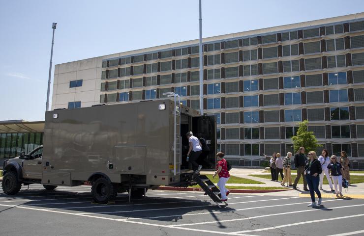 <p>The GTRI Research Electronic Warfare Truck (GREWT), a modified Ford F-550 truck shown here being toured by members of the Honorary Commanders Alumni Association, supports field testing of aircraft defensive systems. (Credit: Sean McNeil, GTRI)</p>