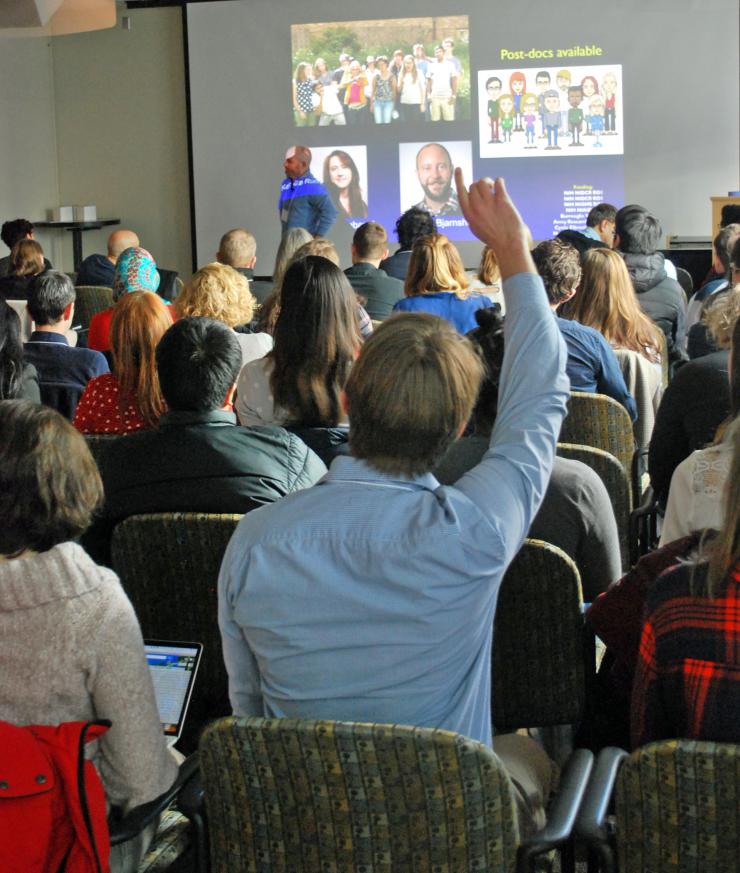 <p>Petit Institute researcher Will Ratfliff raises his hand to ask a question of fellow Petit Institute researcher Marvin Whiteley during the last presentation of the 2018 Suddath Symposium.</p>