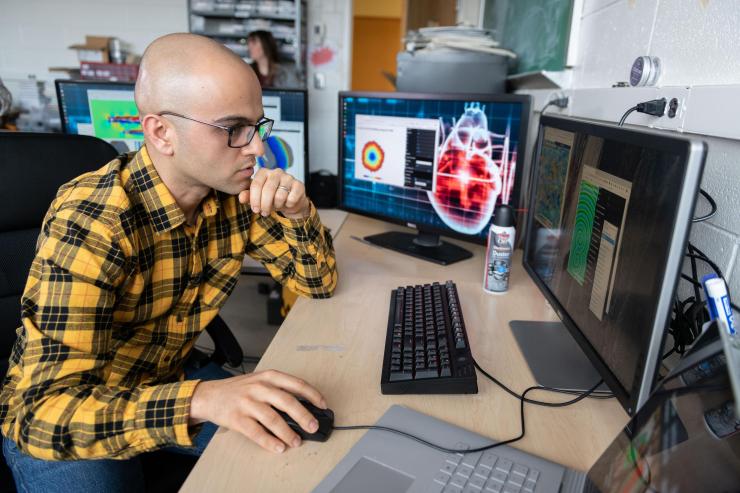 <p>Georgia Tech Research Scientist Abouzar Kaboudian examines cardiac and fluid flow simulations created on a system that uses graphics processing chips designed for gaming applications and software that runs on ordinary web browsers. (Photo: Allison Carter, Georgia Tech)</p>