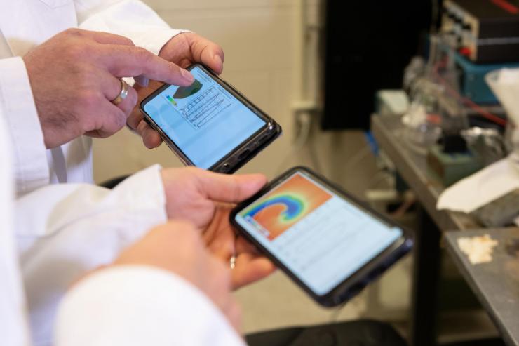<p>Smartphone screens show cardiac arrhythmia simulations running on the graphics processing units of the mobile devices using the new software. (Photo: Allison Carter, Georgia Tech)</p>