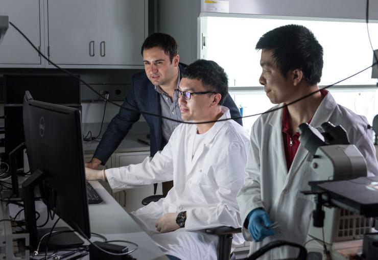 <p>Georgia Tech researchers have developed a hybrid microfluidic chip that could provide the electronic intelligence that might one day allow inexpensive labs on a chip to conduct sophisticated medical testing outside the confines of hospitals and clinics. Shown are (l-r) Fatih Sarioglu, Ningquan Wang and Ruxiu Liu. (Credit: Rob Felt, Georgia Tech)</p>