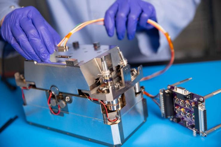 <p>Researchers in Georgia Tech’s School of Aerospace Engineering assemble the Lunar Flashlight’s propulsion system, which will use a special “green” monopropellant to perform course correction maneuvers. (Credit: Candler Hobbs)</p>