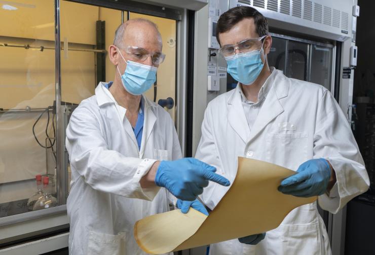 Associate Professor Ryan Lively from Georgia Tech’s School of Chemical and Biomolecular Engineering and Professor M.G. Finn from the School of Chemistry and Biochemistry examine membrane material produced at Imperial College based on a new polymer material. (Credit: Christopher Moore, Georgia Tech)