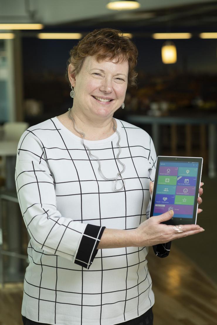 <p>Elizabeth Mynatt, executive director of the Georgia Tech Institute for People and Technology and a professor in the Georgia Tech School of Interactive Computing, holds a tablet computer running the MyPath application. (Photo: Christopher Moore, Georgia Tech)</p>