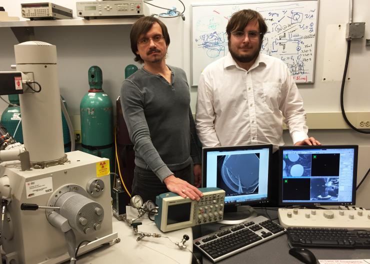 <p>Using nanoelectrospray, researchers have demonstrated a new process for rapidly fabricating complex three-dimensional nanostructures from a variety of materials, including metals. Shown in the laboratory where the work was done are Professor Andrei Fedorov (left) and graduate student Jeffrey Fisher. (Credit: John Toon, Georgia Tech)</p>