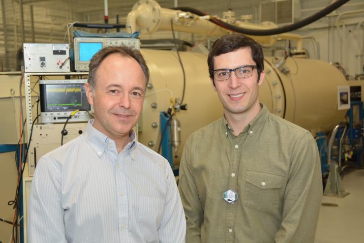<p>University of Michigan Professor Igor Jovanovic and Graduate Student Jason Nattress are shown in front of an ion accelerator at the Michigan Ion Beam Laboratory. Beams produced by this type of source have been used to interrogate shielded special nuclear materials. (Courtesy Igor Jovanovic)</p>
