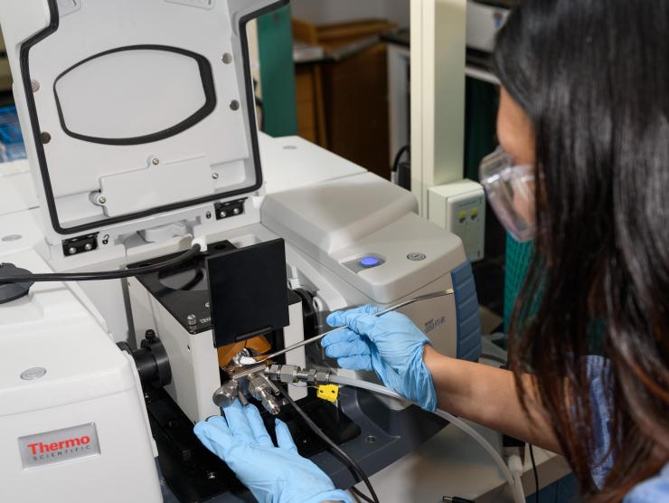 <p>Georgia Tech graduate research assistant Yu-Hsuan Liu places a sample of titanium dioxide into test equipment in the laboratory of assistant professor Marta Hatzell. (Credit: Rob Felt, Georgia Tech)</p>