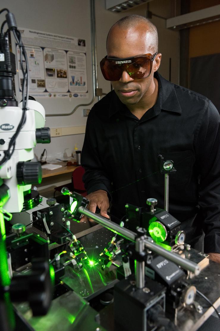 <p>Georgia Tech associate professor Baratunde Cola measures the power produced by converting green laser illumination to electricity using the carbon nanotube optical rectenna. (Credit: Rob Felt, Georgia Tech)</p>