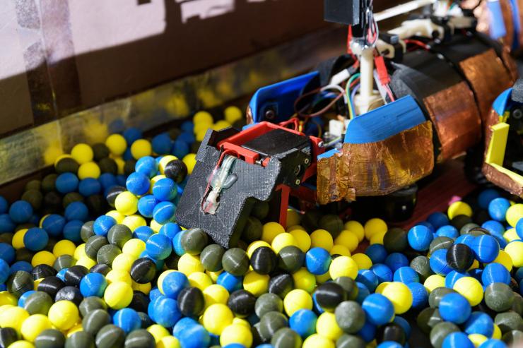 <p>Image shows a robot built in the laboratory of Professor Daniel Goldman at Georgia Tech designed to dig 3D printed spheres that are intended to simulate the moist soil in which ants dig. (Credit: Rob Felt, Georgia Tech)</p>