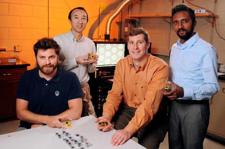 <p>The Georgia Tech Research Institute (GTRI) team (left-to-right) Stephan Turano, Hunter Chan, Jud Ready and Kavin Manickaraj show textured thin film photovoltaic devices based on earth-abundant materials. (Credit: Gary Meek, Georgia Tech)</p>