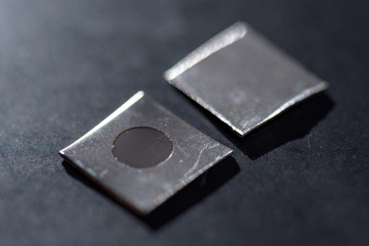 <p>Close-up image shows an untreated stainless steel sample (right), and a sample that has been electrochemically treated to create a nanotextured surface. The sample was prepared by using a potentiostat in Professor Preet Singh's laboratory at Georgia Tech. (Credit: Rob Felt, Georgia Tech)</p>