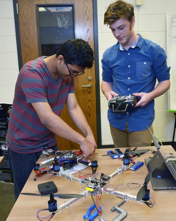 <p>Amulya Bajracharya of Marietta High School and Conor Hagan of Kennesaw Mountain High School discuss building a quadrotor unmanned aerial vehicle. (Credit: Rick Robinson)</p>