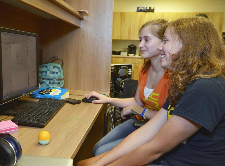 <p>Amanda Ziegler, left, and Camillia Beckett of Lithia Springs High School work on part of a NASA project that involves capturing an asteroid and moving it into a moon orbit. (Credit: Rick Robinson)</p>