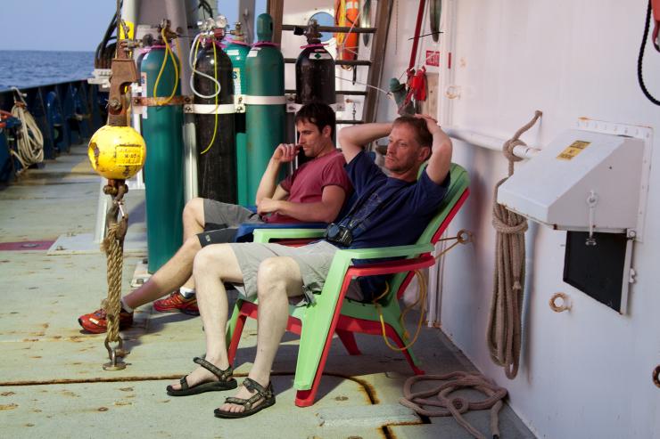 <p>Georgia Tech researcher Frank Stewart (background) sits with the paper's co-authro, Bo Thamdrup from the University of Sourthern Denmark on a research ship that took them to an oxygen minimum zone, where they hauled up the newly discovered bacteria. Photo: Dr. Heather Olins</p><p> </p>