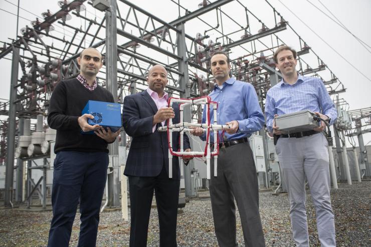 <p>Georgia Tech researchers Tohid Shekari, Raheem Beyah, Morris Cohen, and Lukas Graber hold an antenna and home-built recording equipment for the VLF radio receiver, known as AWESOME, which is capable of detecting lightning radio bursts from around the world. (Image: Christopher Moore, Georgia Tech)</p>