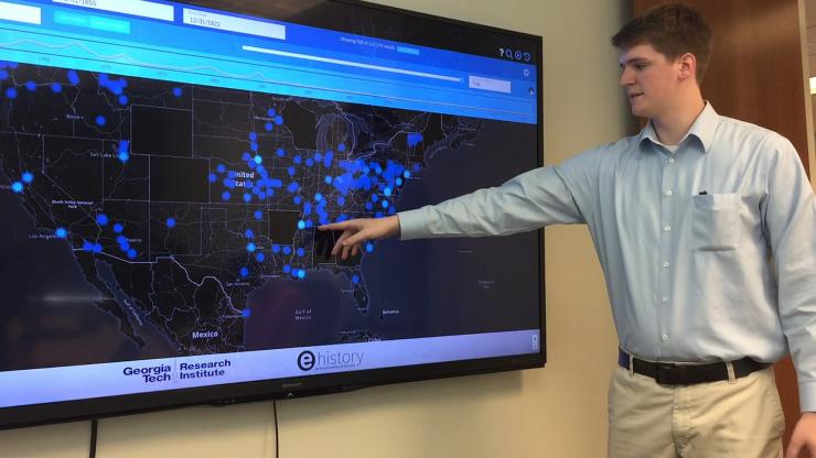 <p>Georgia Tech Research Institute (GTRI) Research Scientist Trevor Goodyear shows features of U.S. News Map, a database of more than 10 million newspaper pages that is helping researchers see history with spatial information that hadn’t been available before. (Credit: Georgia Tech).</p>