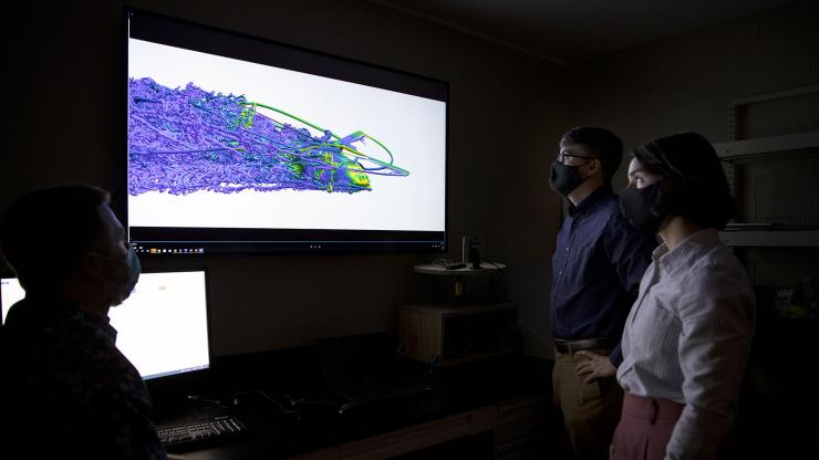 <p>GTRI researchers Jesus Arias, Maia Gatlin and Andrew Harper discuss how information from computational fluid dynamics (CFD) simulations may apply to the Virtual Sensing Technologies for Accelerometer Reconstruction (VSTAR) program. (Credit: Sean McNeil, GTRI)</p>