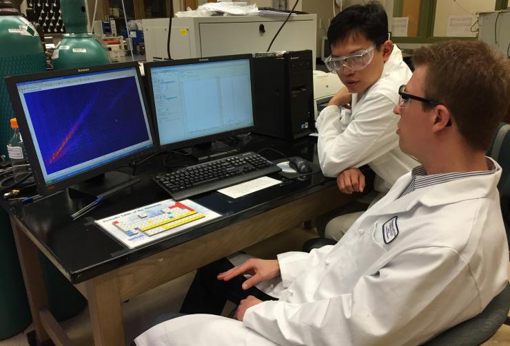 <p>Georgia Tech postdoctoral fellow Jay Forsythe and graduate student Sheng-Sheng Yu discuss the results of mass spectrometry analysis of samples that had been subjected to repeated cycles of wet-dry conditions. (Photo: John Toon, Georgia Tech)</p>