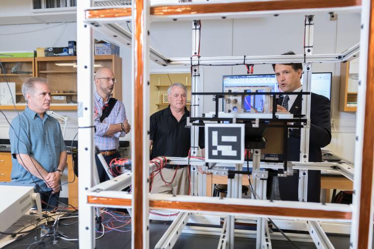 <p>Brian Gunter, assistant professor in Georgia Tech’s Guggenheim School of Aerospace Engineering, shows the small satellite testing facilities in his lab to Xenesis leadership. Shown (l-r) are Neal Campion, Xenesis Strategy Director; Mark LaPenna, Xenesis CEO and founder; Mike Carey, chief strategy Officer at Atlas Space Operations, and Gunter. (Credit: Allison Carter, Georgia Tech)</p>

<p> </p>