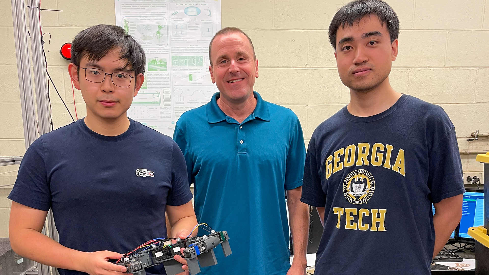 Ph.D. student Baxi Chong; physics professor Daniel Goldman; and Ph.D. student Tianyu Wang with the lizard robophysical model.