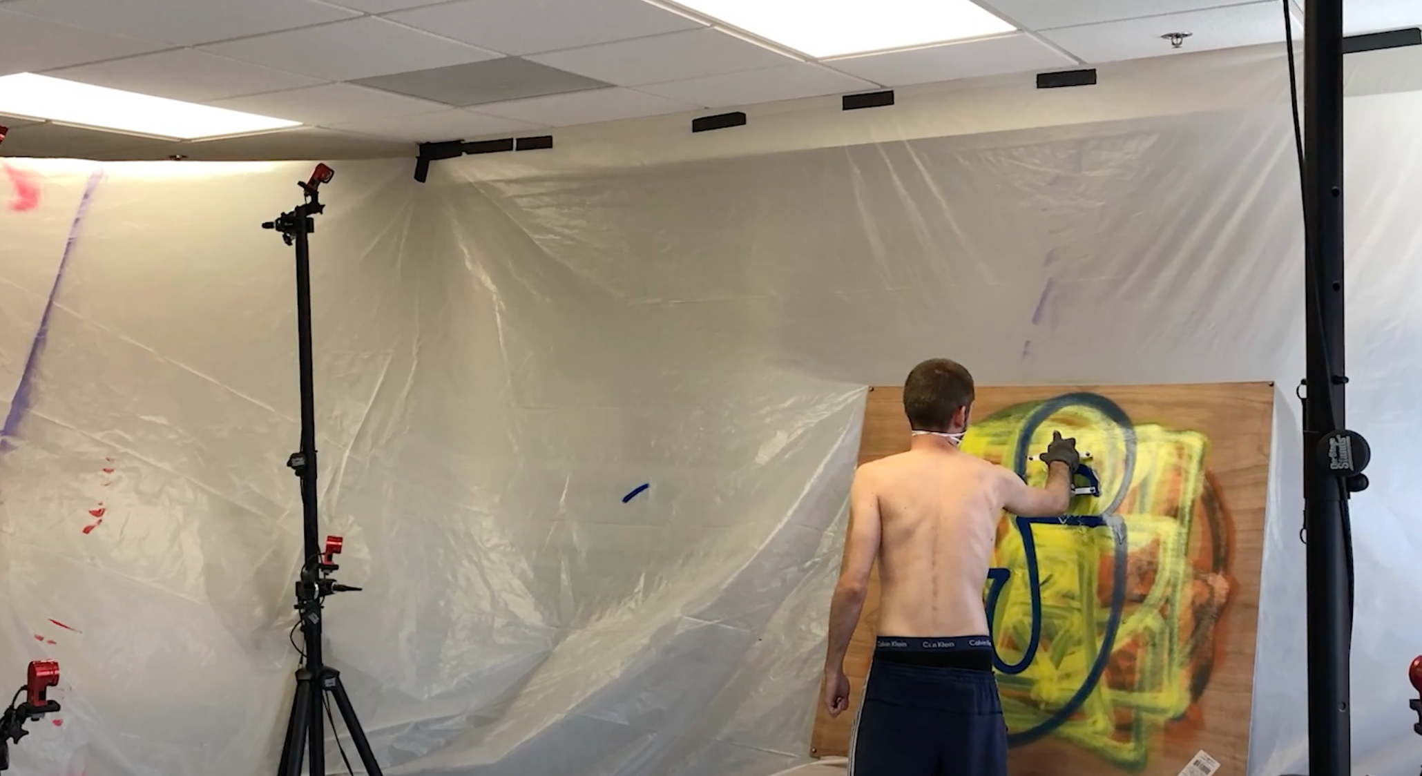 Student spray painting with glove sensor