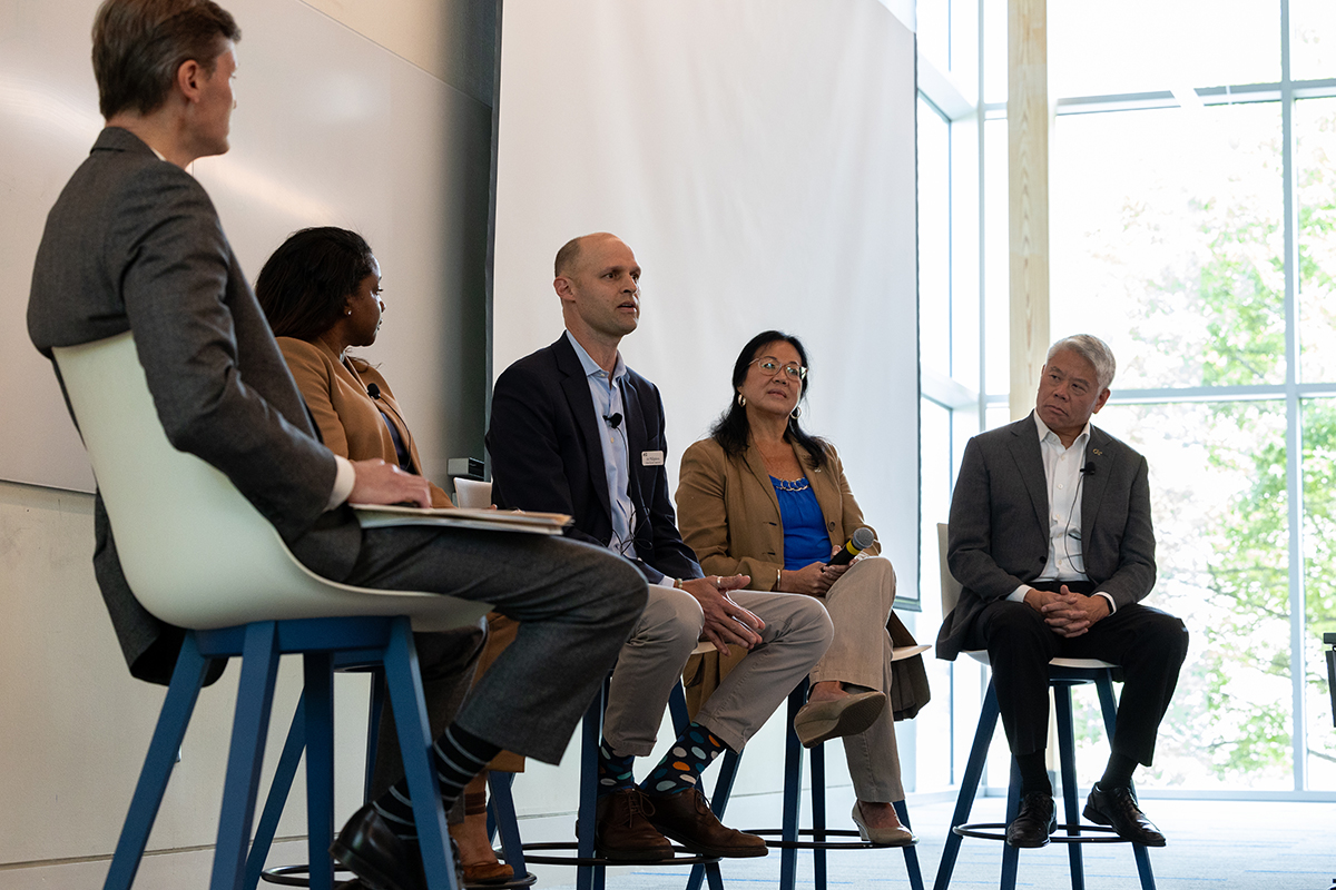 a group of people sitting in chairs on a stage