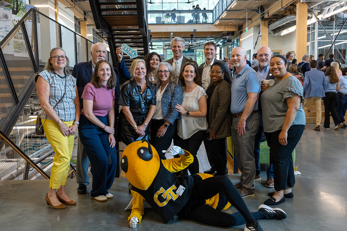 Student-led Georgia Tech Energy Club Team in a lobby with Buzz, GT's mascot