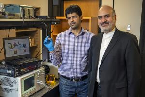 ECE professor Ali Adibi with Ph.D. candidate Sajjad Abdollahramezani holding their packaged tunable meta surface device.  Ali’s Photonics Research Group lab where the characterization of the tunable metasurfaces takes place.