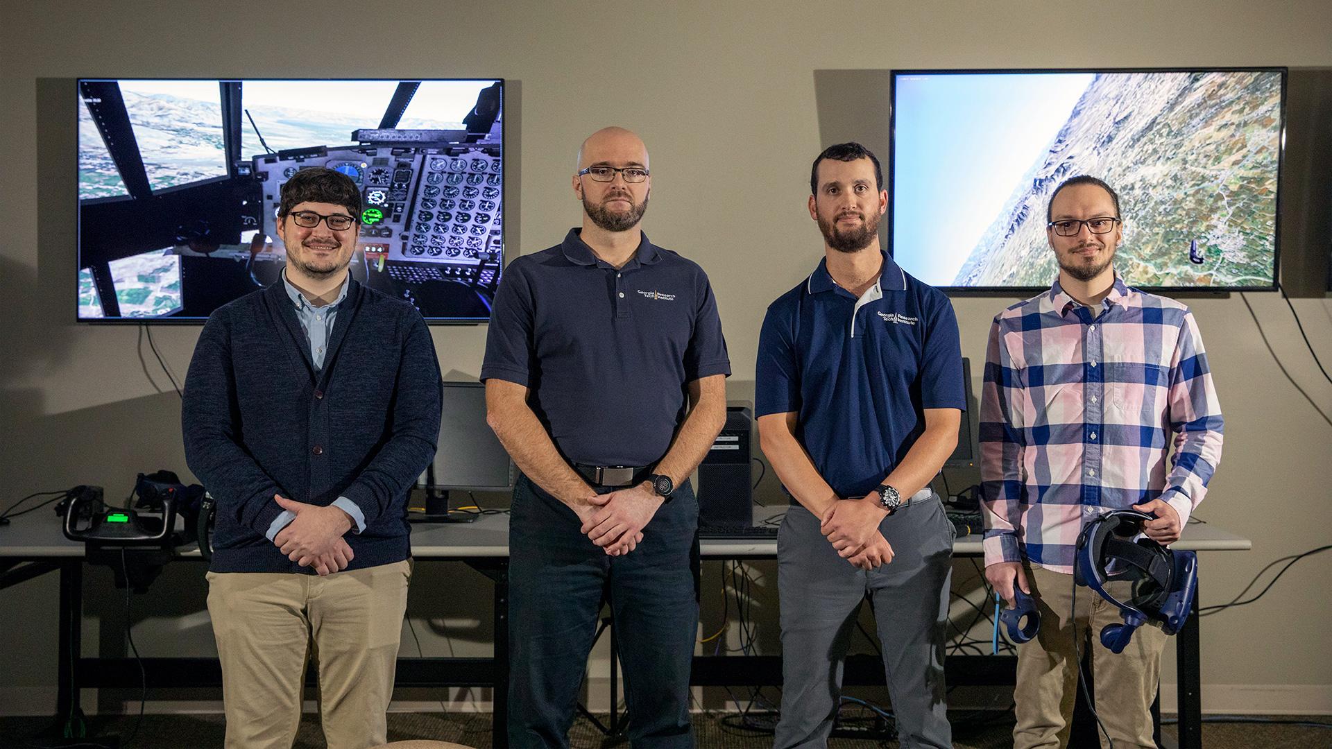 A GTRI research team has worked with the 189th Airlift Wing to develop a high-fidelity immersive multi-player simulation of the battle airspace. Shown (l-r) are: Matthew Hansen, Izudin Ibrahimbegovic, Andrew Braun, and Robert Plante. (Credit: Sean McNeil, GTRI)
