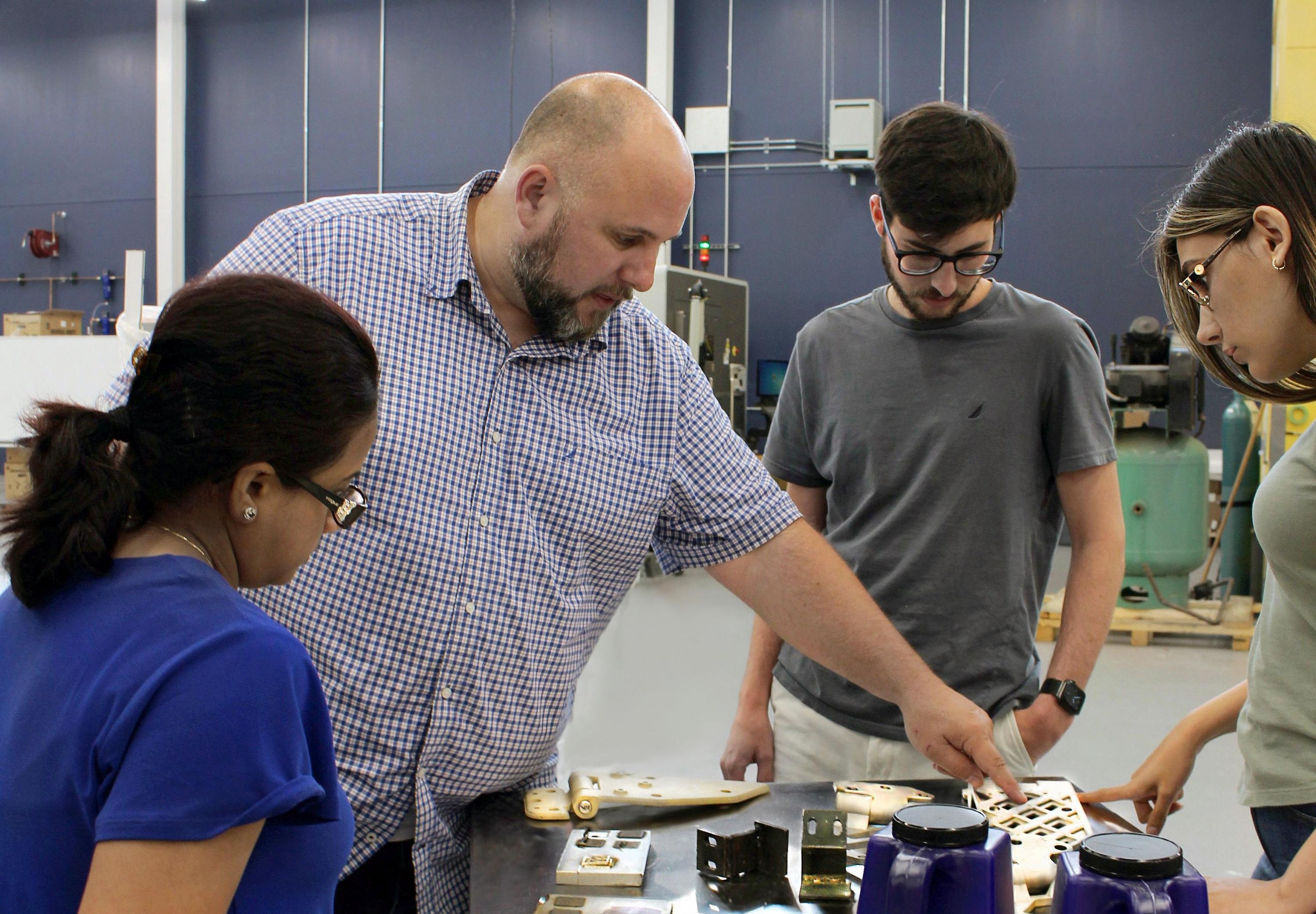 Aaron Stebner (second from left), associate professor in the College of Engineering, leads a lab session with students in the Delta Air Lines Advanced Manufacturing Pilot Facility at Georgia Tech. (Photo: Christa M. Ernst)