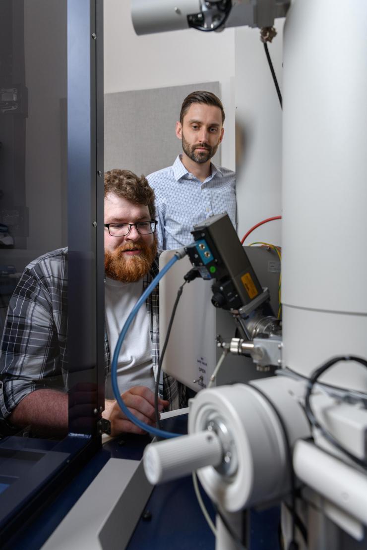 <p>Matthew Boebinger, a graduate student at Georgia Tech, and Matthew McDowell, an assistant professor in the George W. Woodruff School of Mechanical Engineering and the School of Materials Science and Engineering, used an electron microscope to observe chemical reactions. (Credit: Rob Felt)</p>